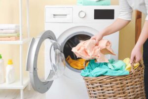 Donna che mette bucato nella lavatrice